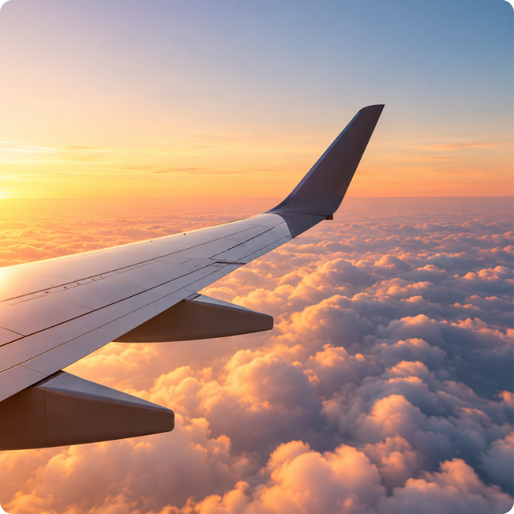 Asa de avião sobre as nuvens ao pôr do sol